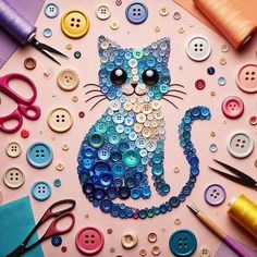 a cat made out of buttons sitting on top of a piece of paper next to scissors