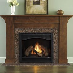 a fire place in a living room with a painting on the wall