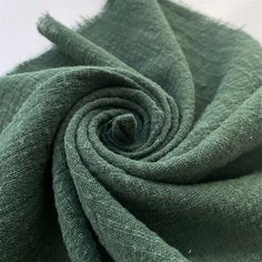 a close up view of a green fabric on a white background, with the center section showing