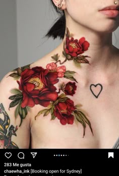 a woman with red flowers on her chest has a black heart in the middle of her chest