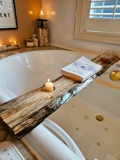 a candle is sitting on the edge of a bathtub with candles in front of it