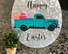 a happy easter sign next to a potted plant on a granite countertop with an old truck carrying eggs