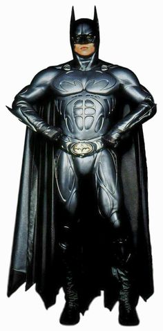 a man dressed as batman standing with his hands on his hips