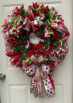 a christmas wreath with candy canes, candies and a santa clause on it