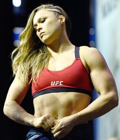 a woman in a red sports bra posing for the camera