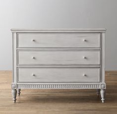 a white dresser sitting on top of a wooden floor