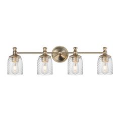 three light bathroom fixture with clear glass shades on the bottom and gold metal fixtures,