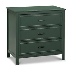 a green chest of drawers sitting on top of a white floor