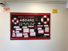 a bulletin board on the wall with information about life rafts and other things attached to it