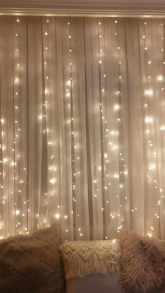 a living room filled with lots of lights next to a window covered in sheer curtains