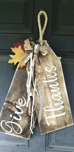 a door hanger that says welcome fall and has an autumn leaf hanging from it