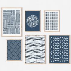 six blue and white art prints hanging on a wall in different shapes, sizes and colors