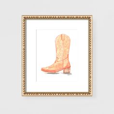 an orange cowboy boot is framed in a gold frame