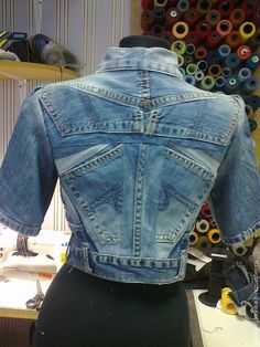 a woman's jean jacket on display in a shop