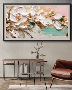 a painting hanging on the wall above a table