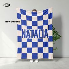 a blue and white checkered blanket with the word nattalia printed on it