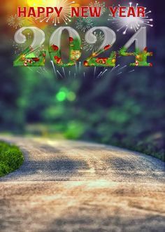 a happy new year card with fireworks on the road and green grass in the foreground