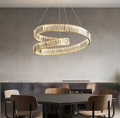 a modern chandelier hanging over a dining room table