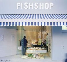 a fish shop with people standing in front of it