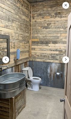 a bathroom with wooden walls and a metal sink