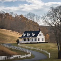 a large white house sitting on top of a lush green field next to a road