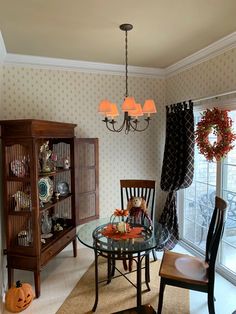 the dining room is decorated for halloween with pumpkins