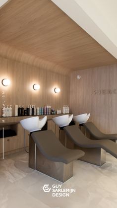 the interior of a modern salon with chairs and counter space for hair care products on display