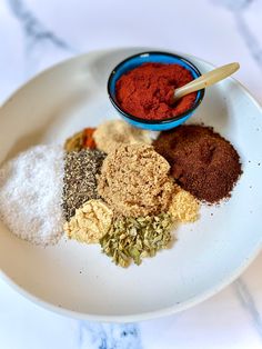 various spices and seasonings on a white plate