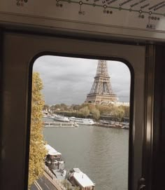 the eiffel tower is seen through an open window