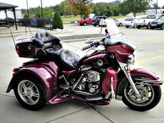 a red motorcycle parked in a parking lot