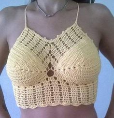 a woman wearing a yellow crochet bra top