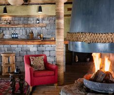 a living room filled with furniture and a fire place in front of a brick wall