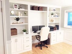 an office with white bookcases, desk and computer on top of the desk