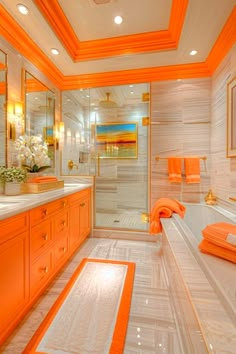 an orange and white bathroom with two sinks, shower, and bathtub in it