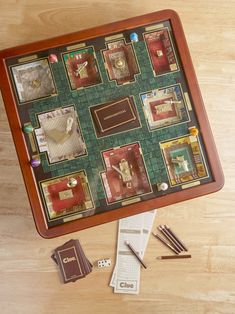 a board game with cards, dices and other items on a wooden table top