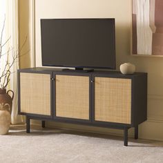 a flat screen tv sitting on top of a wooden cabinet