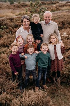 an older man standing with his family in a field