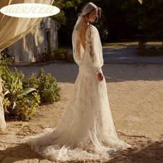 a woman in a wedding dress is standing under an awning with her back to the camera