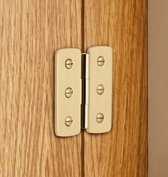 a wooden door with two metal latches on it