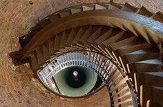 a spiral staircase in an old brick building