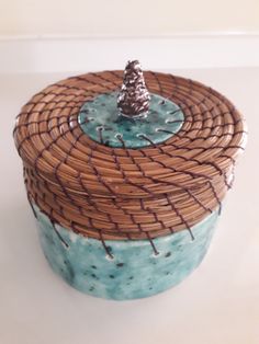 a basket with a small pine cone on top