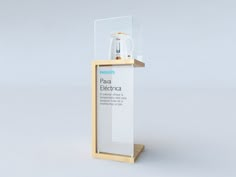 an electronic device is displayed in a glass display case on a wooden stand with a white background