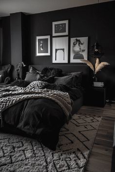 a black and white bedroom with pictures on the wall