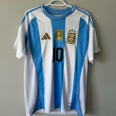 a soccer jersey hanging on a wall with the number 10 on it's chest