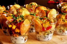 small cups filled with food sitting on top of a wooden table