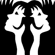 two women's faces are shown in black and white, with the silhouettes of their heads facing each other