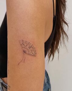 a woman's arm with a small tattoo design on the left side of her arm