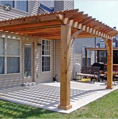 an outdoor covered patio with wooden pergols