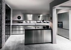 a large kitchen with stainless steel appliances and counter tops is shown in black and white