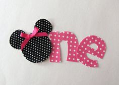 the word mickey and minnie mouse is made out of polka dot paper with a pink bow